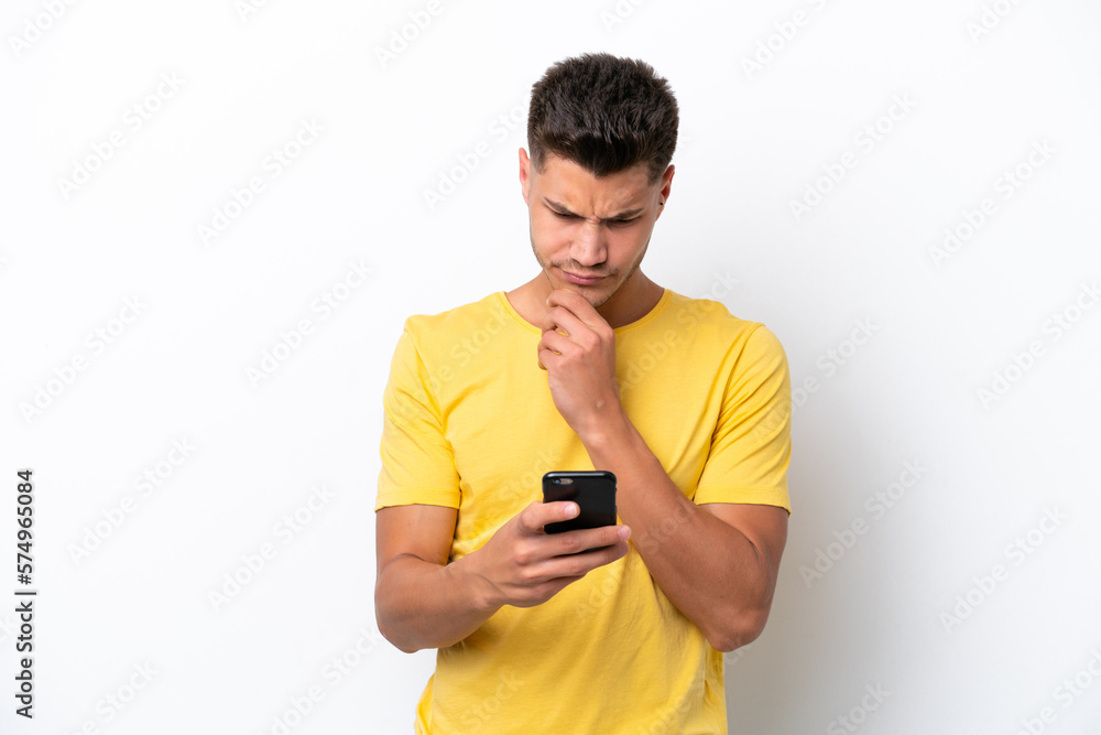 Young caucasian man isolated on white background thinking and sending a message Young caucasian man isolated on white background thinking and sending a message