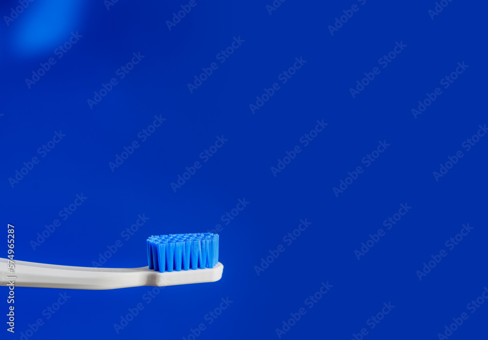 white toothbrush on blue background copy space. the concept of oral hygiene, dental care. Dental concept. health care. Oral hygiene. white toothbrush on blue background copy space. the concept of oral hygiene, dental care. Dental concept. health care. Oral hygiene.
