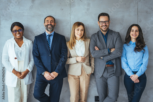 Fotografija The business people standing on the gray wall background