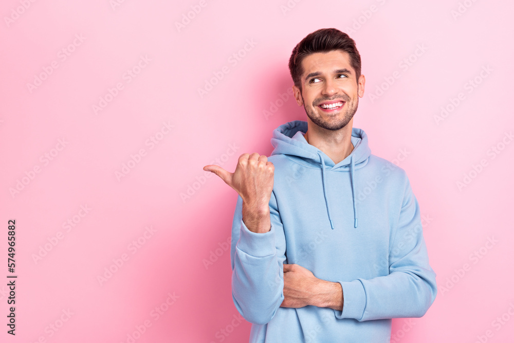 Portrait of positive man arm thumb demonstrating empty space visit nice restaurant cafe delicious food isolated on pink color background