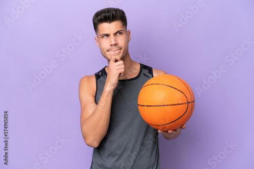 young caucasian woman basketball player man isolated on purple background having doubts and thinking