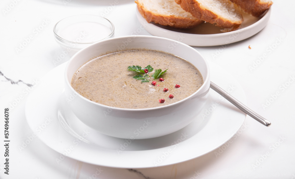 Creamy champignon soup in a white bowl. Creamy champignon soup in a white bowl.