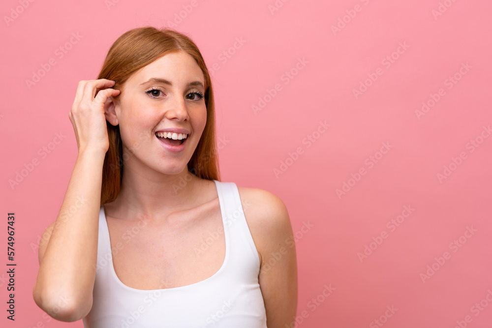 Young redhead woman isolated on pink background Young redhead woman isolated on pink background
