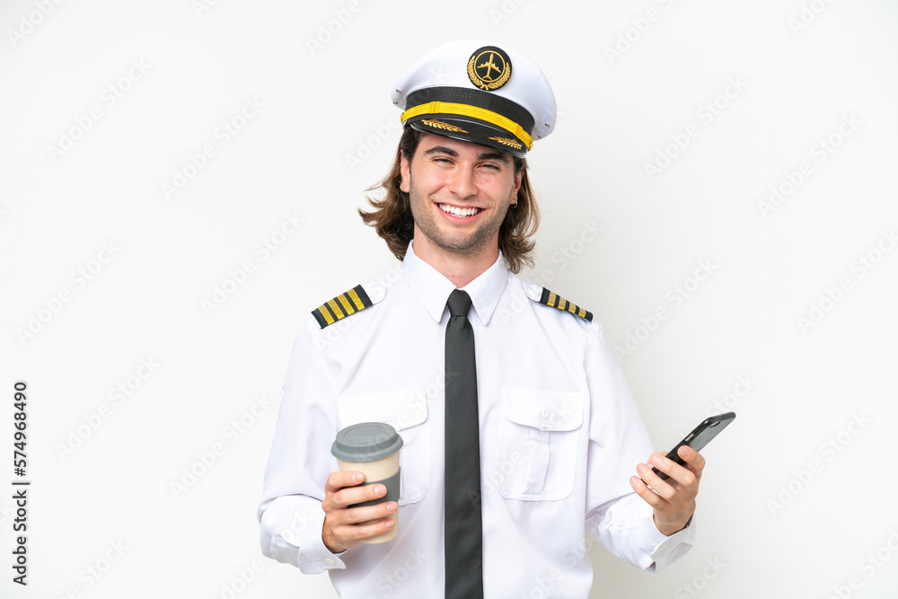 handsome Airplane pilot isolated on white background holding coffee to take away and a mobile handsome Airplane pilot isolated on white background holding coffee to take away and a mobile