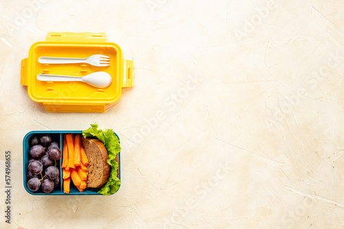 Lunch box set with bread fruits and vegetables, top view