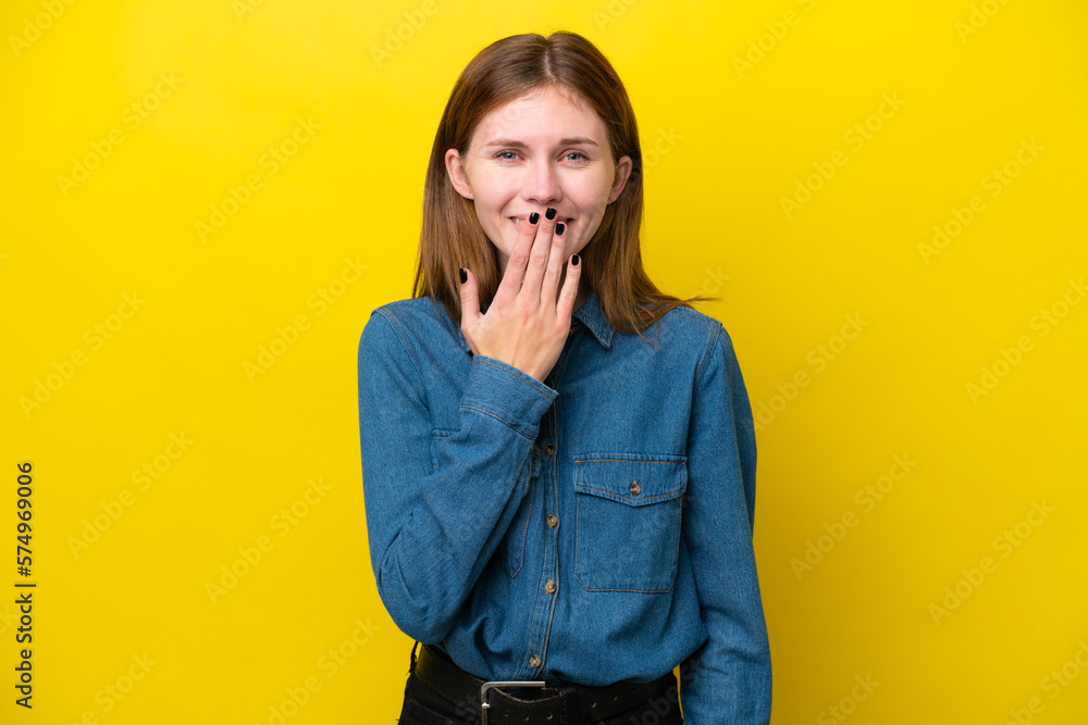 Young English woman isolated on yellow background covering mouth with hand Young English woman isolated on yellow background covering mouth with hand
