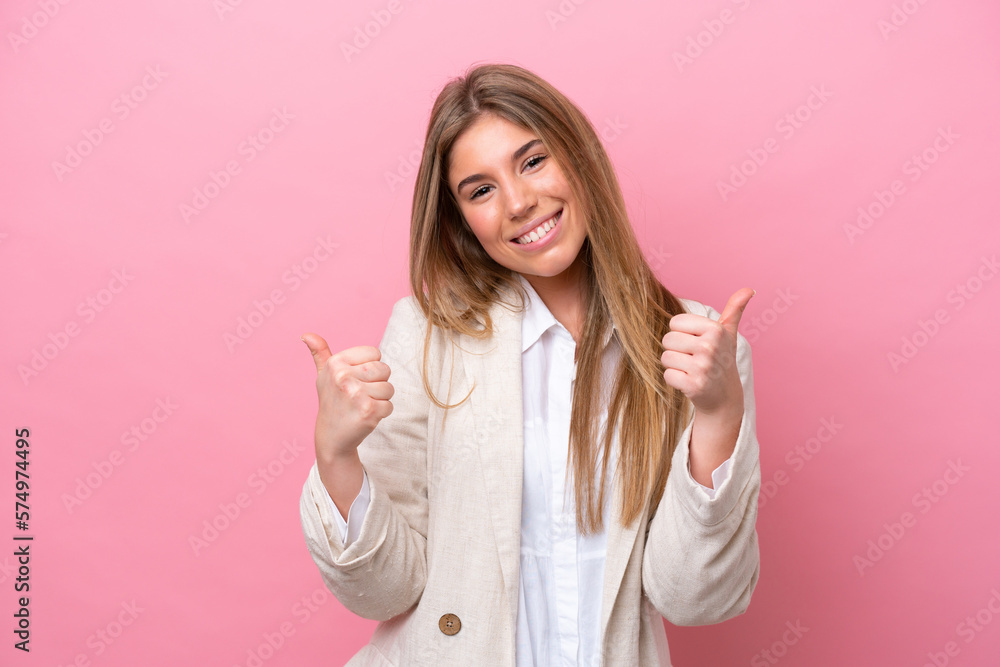 Young caucasian woman isolated on pink bakcground with thumbs up gesture and smiling Young caucasian woman isolated on pink bakcground with thumbs up gesture and smiling