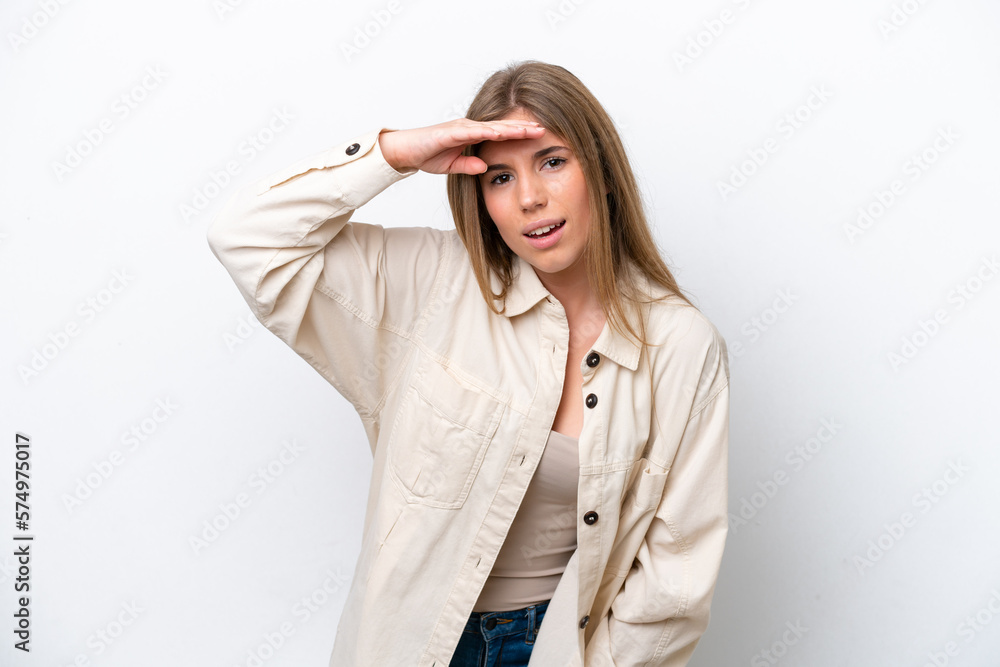 Young caucasian woman isolated on white bakcground looking far away with hand to look something Young caucasian woman isolated on white bakcground looking far away with hand to look something
