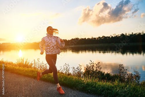 Woman runs in the park on autumn morning. Healthy lifestyle concept, people go in sports outdoors. Silhouette family at sunset. Fresh air. Health care, authenticity, sense of balance and calmness. 