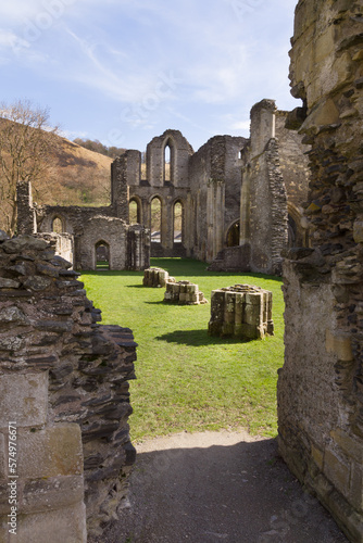 The ruins of Valle Crucis Abbey viewed dining hall. Founded as a Cistercian monastery in 1201 and closed in 1537 it is a prominent landmark in the vale of Llangollen Wales photo