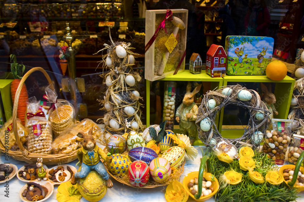 Traditional colorful Easter chocolate eggs and rabbits in a confectionery storefront in Brussels