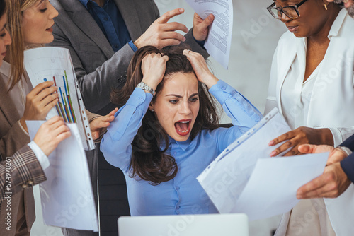 Fotografija Shot of a young businesswoman looking anxious in a demanding office environment
