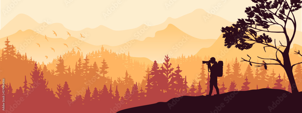 Naklejka premium Photographer stands on hill take picture of landscape. Mountains and forest in background. Orange silhouette illustration. Banner. 