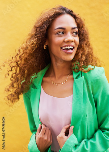 Happy, smile and fashion with black woman in city for freedom, beauty and glow. Cosmetics, confidence and youth with girl and yellow urban wall background for happiness, satisfaction and style