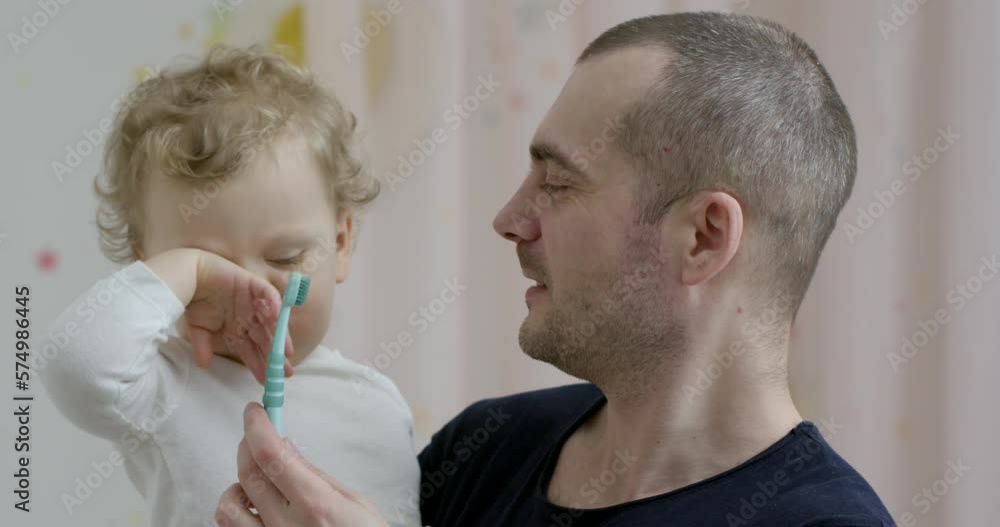 Cute baby 2 years old brushes his teeth with a toothbrush. The concept of oral hygiene and healthy teeth from infancy. Cute baby 2 years old brushes his teeth with a toothbrush. The concept of oral hygiene and healthy teeth from infancy.