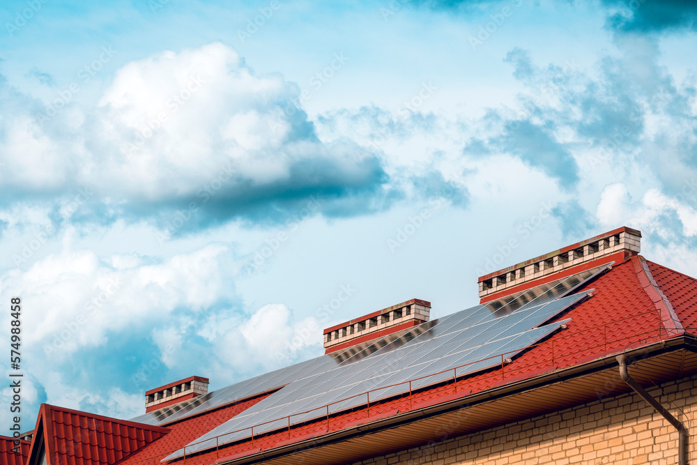 Photovoltaic or solar panels on a house with a red roof Photovoltaic or solar panels on a house with a red roof