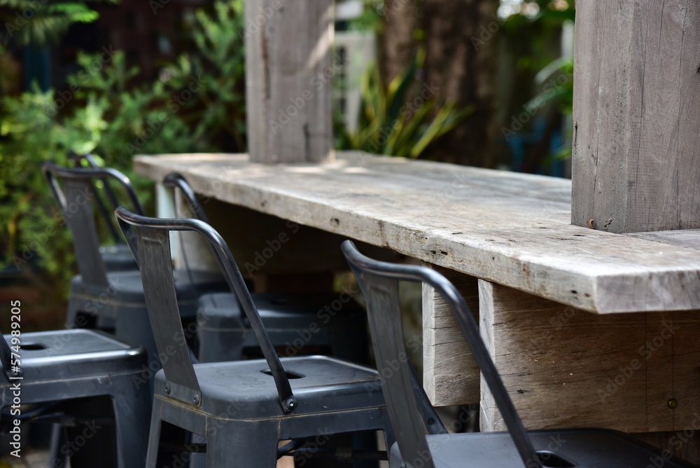 Table and chairs in outdoor cafe near  the garden.