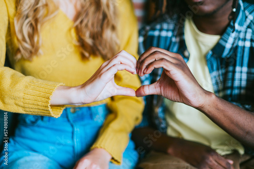 couple caucasian girl and young african american man, friends support each other in difficult times, mental health and support, holding hands in shape of heart, people of different races