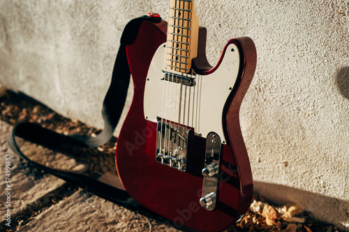 Red Electric guitar in the late afternoon sun with heart engraved onto pickguard
