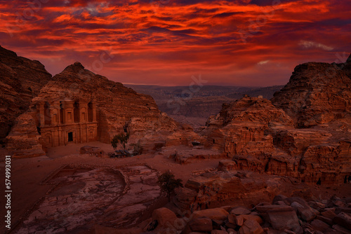 Stone Monastery in rock, Petra in Jordan. Red rock landcape. Petra historical sight - Ad Deir Monastery with full moon during the night. Evening light in nature. Travel in Jordan, Arabia in Asia.