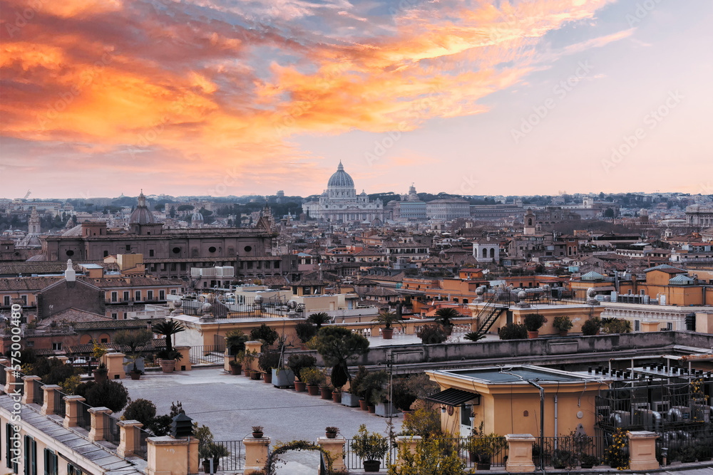 Romantic view of Rome with St Peter's Basilica (San Pietro) in Vatican City, Italy at sunset. It is a famous landmark of Vatican. Nice cityscape of the old Roma in winter