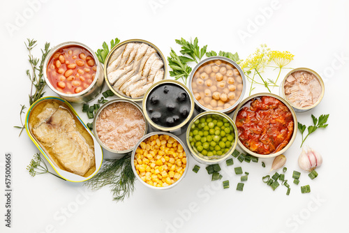 Assortment of processed food in tins, canned vegetables and fish.