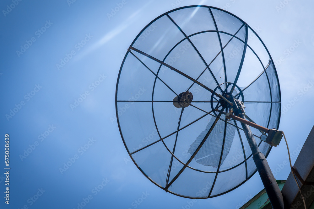 Big C-Band Satellite dish on roof of a house. Option to get free cable TV signal.