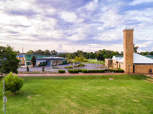 Library with empty carpark and footpath to clock tower
