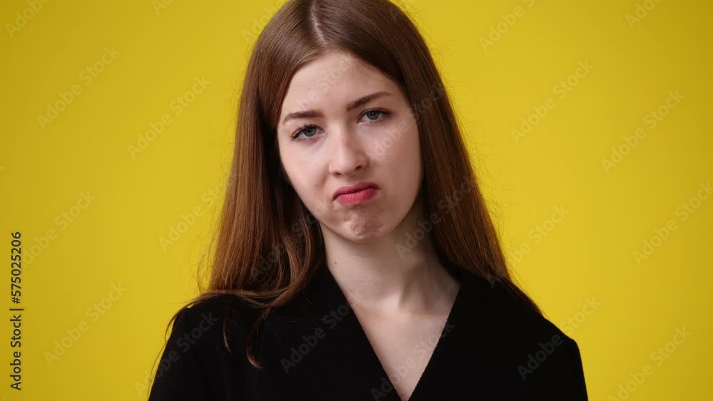 4k video of blank emotion of one girl on yellow background. 4k video of blank emotion of one girl on yellow background.
