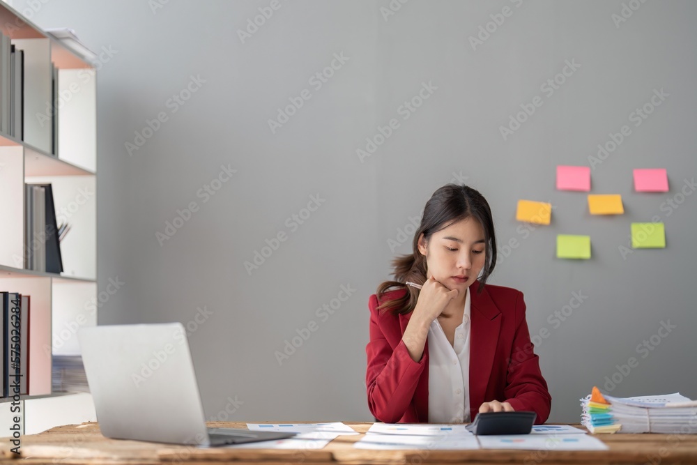 female accountant working on a tablet computer in a modern office. Make an account analysis report. real estate investment information financial and tax system concepts female accountant working on a tablet computer in a modern office. Make an account analysis report. real estate investment information financial and tax system concepts