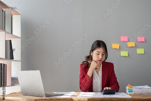 female accountant working on a tablet computer in a modern office. Make an account analysis report. real estate investment information financial and tax system concepts