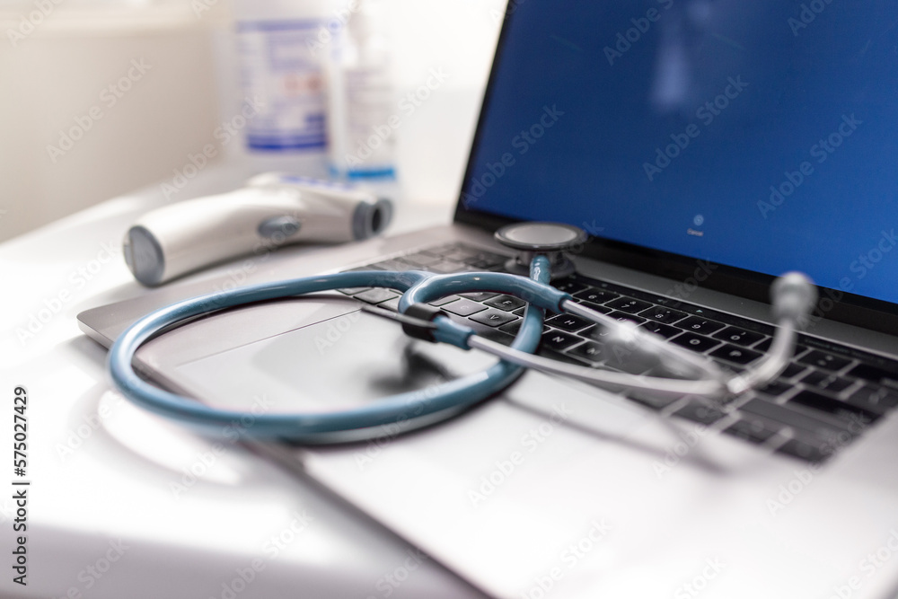 Close up shot of a stethoscope on a laptop keyboard Close up shot of a stethoscope on a laptop keyboard