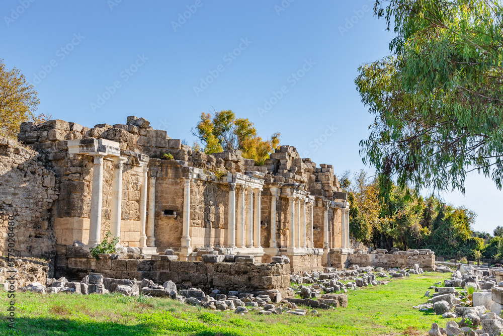 View of of the Nymphaeum Fountain in the ancient town Side at summer day with clear sky. Оne of the most attractive cultural tourism destination in Side (Antalya, Turkey).
