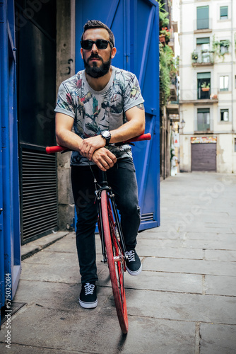 Stylish man with bicycle on street