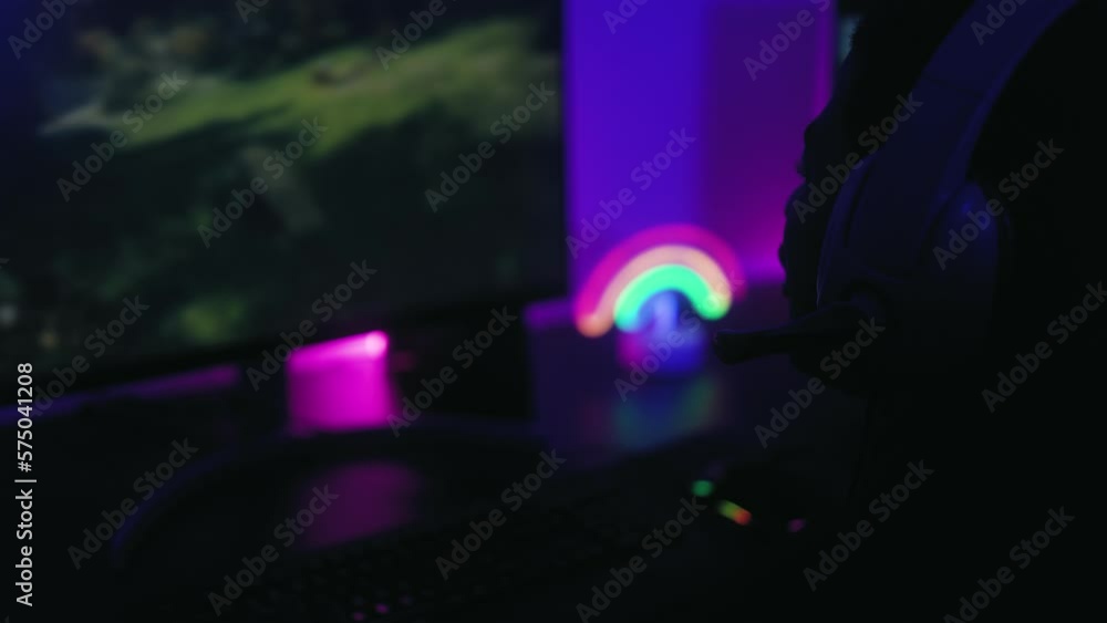 Young gamer playing online video games with computer at home - Gaming entertainment and technology concept