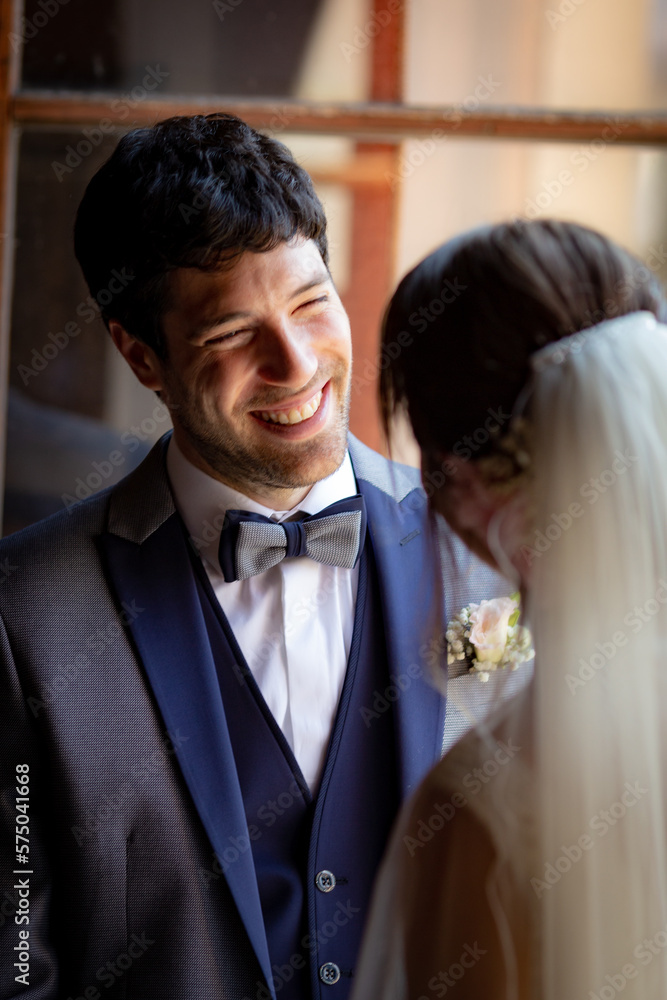 Groom in love and happy looks at his bride Groom in love and happy looks at his bride