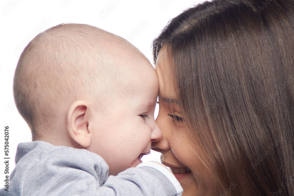 Young girl with a baby in her arms, joy with a newborn laughing Young girl with a baby in her arms, joy with a newborn laughing