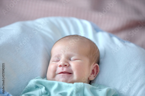 the newborn boy is sleeping. cute beautiful baby is sleeping closeup portrait of a beautiful sleeping baby on white.