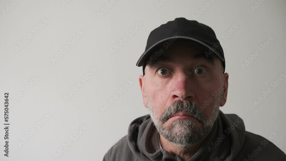 Close up portrait of serious old man with grey beard in the glasses looking astonishment to the camera. Close up portrait of serious old man with grey beard in the glasses looking astonishment to the camera.