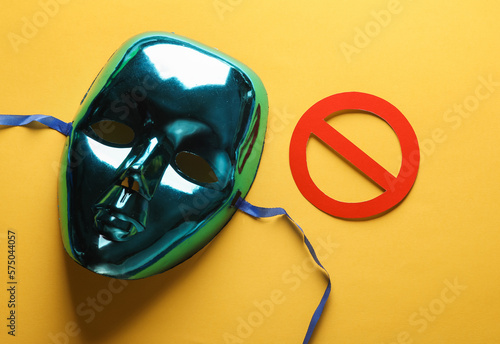Anonymous mask with a prohibition sign on a yellow background. Cyber attack