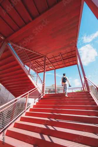 person on red stairs