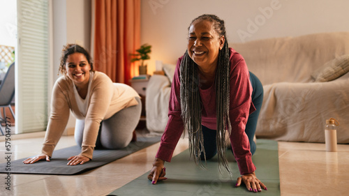 Tela Mother with daughter doing exercises at home