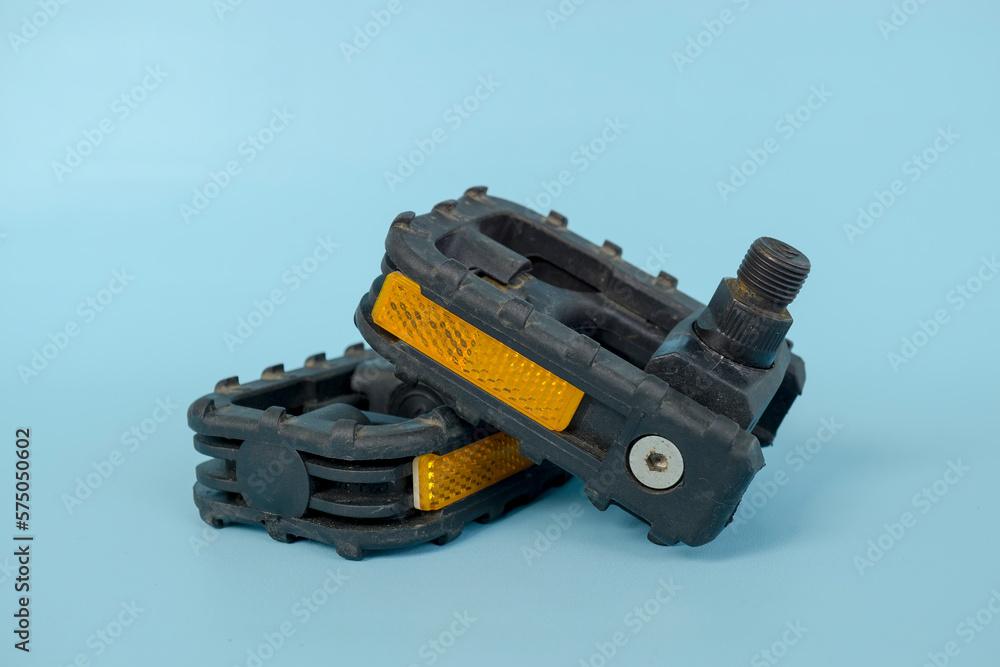 folding bicycle pedals, part of a folding bicycle, isolated on blue background folding bicycle pedals, part of a folding bicycle, isolated on blue background