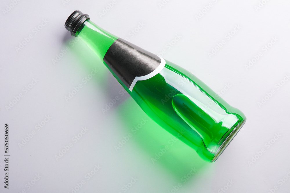 Bottle of green Irish beer on gray background. Top view Bottle of green Irish beer on gray background. Top view
