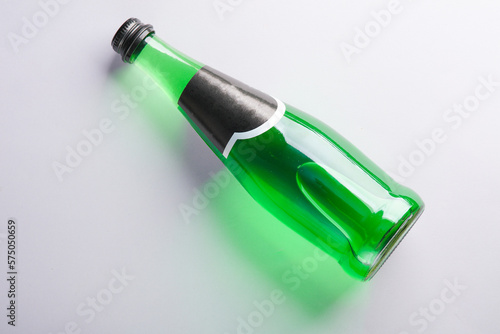 Bottle of green Irish beer on gray background. Top view