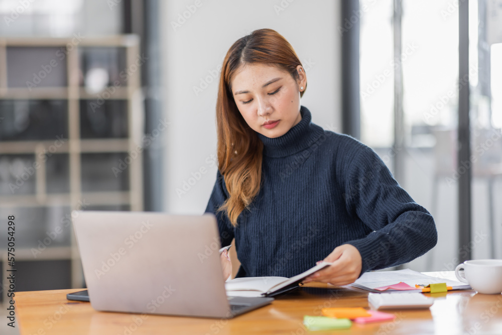 Asian Business woman using calculator and laptop for doing math finance on an office desk, tax, report, accounting, statistics, and analytical research concept
Asian Business woman using calculator and laptop for doing math finance on an office desk, tax, report, accounting, statistics, and analytical research concept