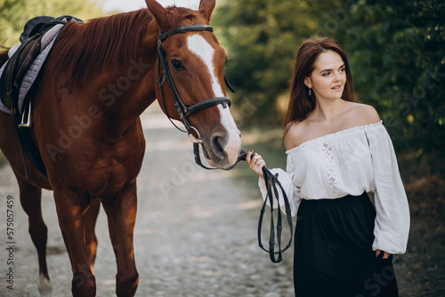 Woman with horse in forest