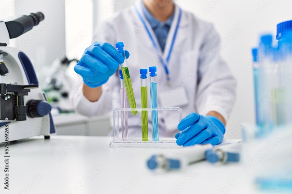Fototapeta premium Young blond man scientist holding test tube at laboratory