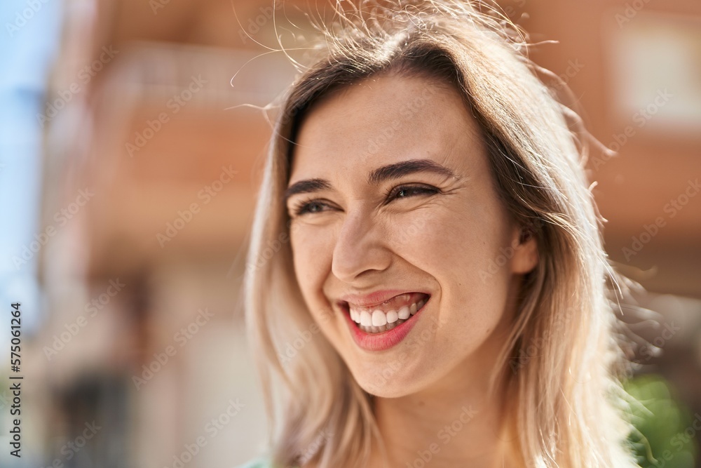 Young woman smiling confident looking to the side at street Young woman smiling confident looking to the side at street