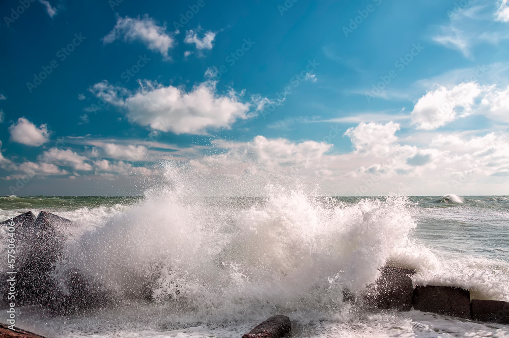 Raging waves crashing on a stone pier. Sea element.
